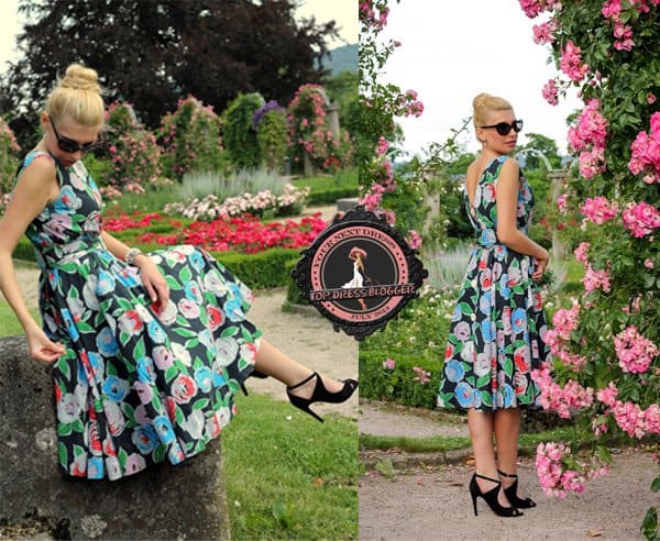 Andy looks lovely in her floral dress and black peep-toe pumps