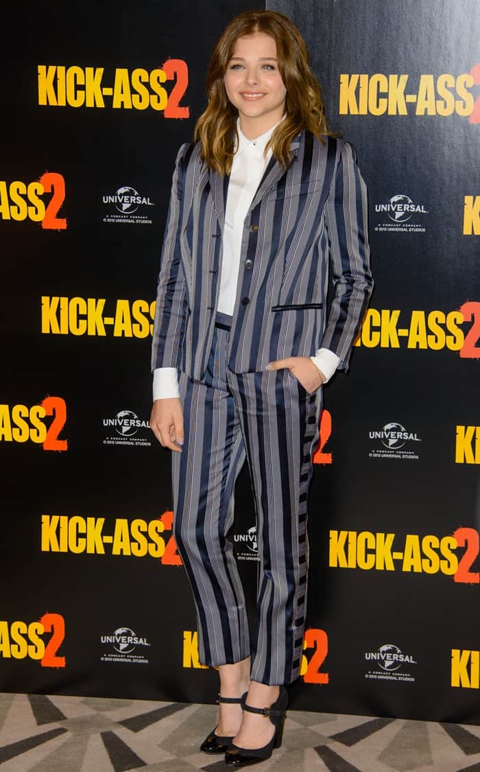 Chloë Moretz stylishly attends the 'Kick-Ass 2' photocall in London, showcasing a Viktor & Rolf grey-and-navy striped suit