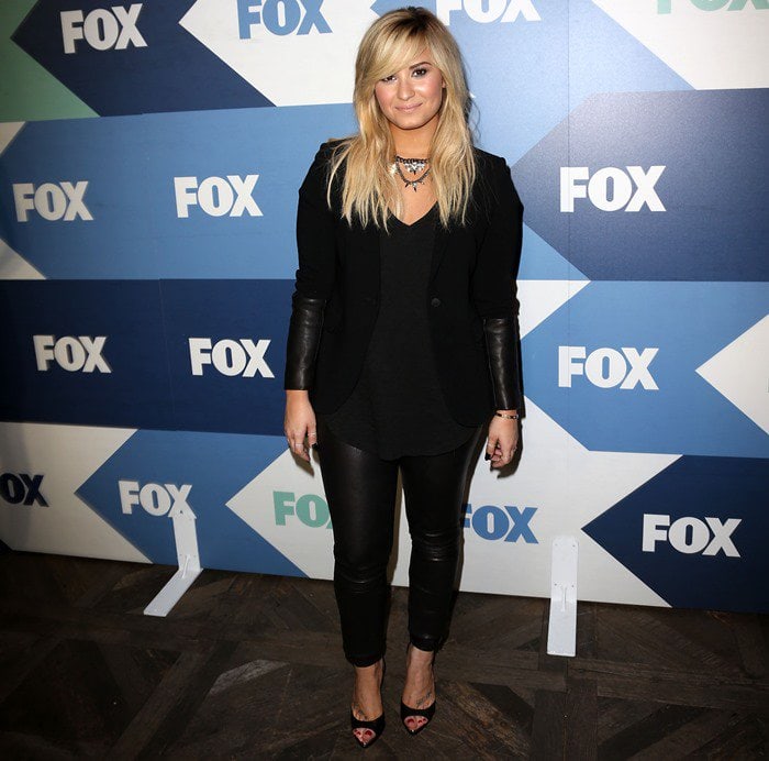 Demi Lovato attended the TCA Summer Tour: Fox All-Star Party on August 1, 2013, in a chic ensemble featuring an ATM Anthony Thomas Melillo slub V-neck tee, Rag & Bone black leather-trimmed timeless blazer, Schutz Constance heels, and Theory Belisa L pants in Danish leather