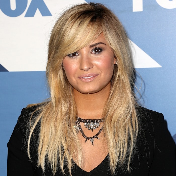 Demi Lovato showcases soft, blonde locks styled in layers and captivating dark brown eyes at the Fox All-Star Party