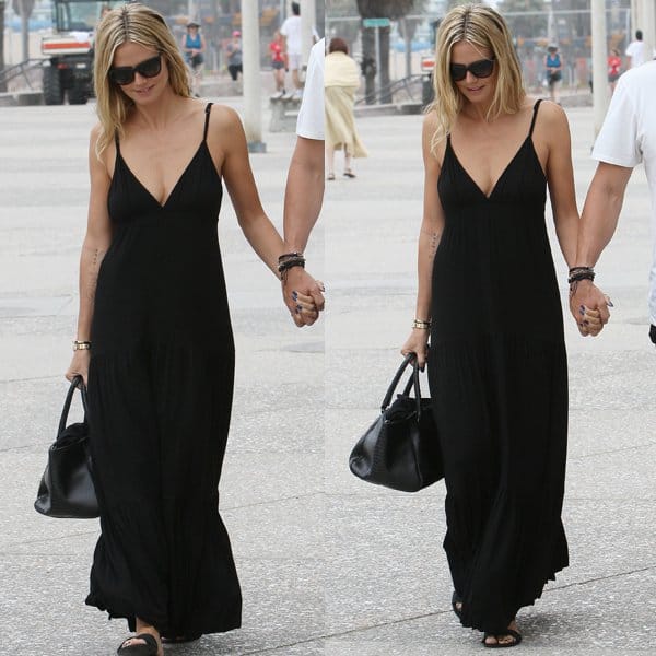 Heidi Klum was spotted at a Starbucks in Brentwood on August 17, 2013, wearing a black LA't by L'AGENCE spaghetti strap maxi dress and carrying a Bottega Veneta Nero waxed python bag