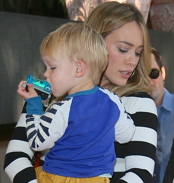 Hilary Duff carries her son Luca Comrie in her arms as she leaves Madeos Restaurant in Los Angeles on October 15, 2013