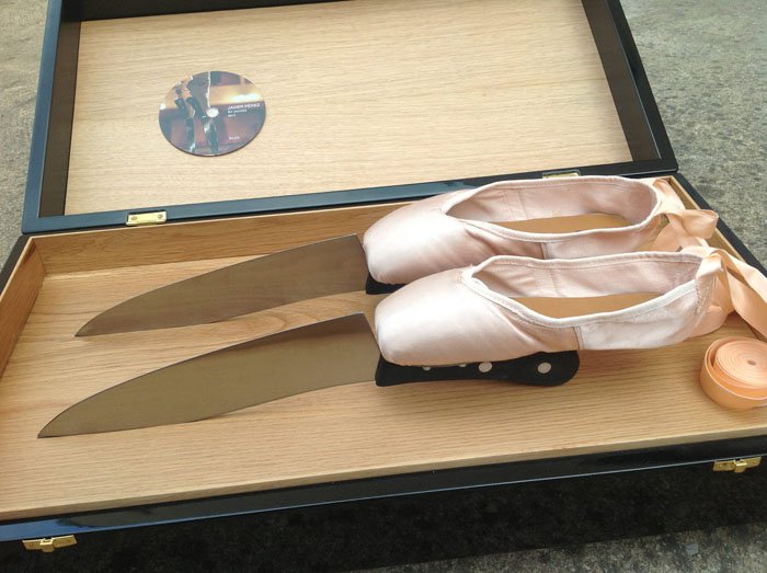 En pointe ballet shoes with kitchen knives attached at the toes