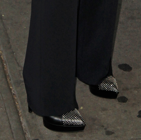 Keri Russell complements her sophisticated black trousers with sleek, studded Saint Laurent booties, perfect for a chic evening ensemble