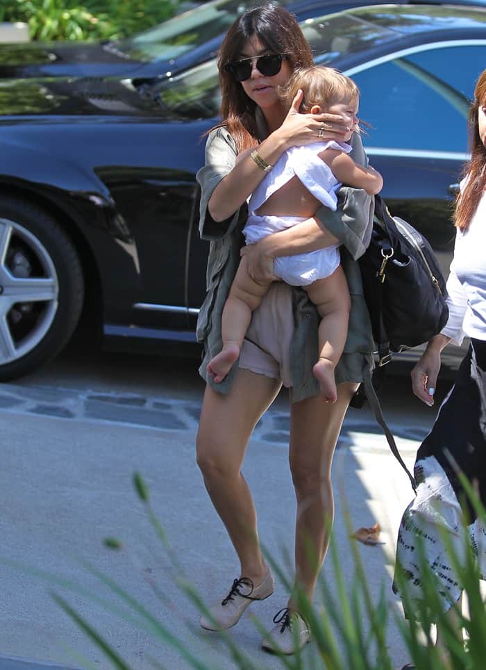 During a Beverly Hills outing, Kourtney Kardashian showcases her chic Prada baby bag, merging luxury with parenting essentials