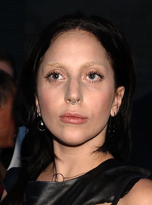 A naturally radiant Lady Gaga sports a nose ring, embracing a minimal makeup look