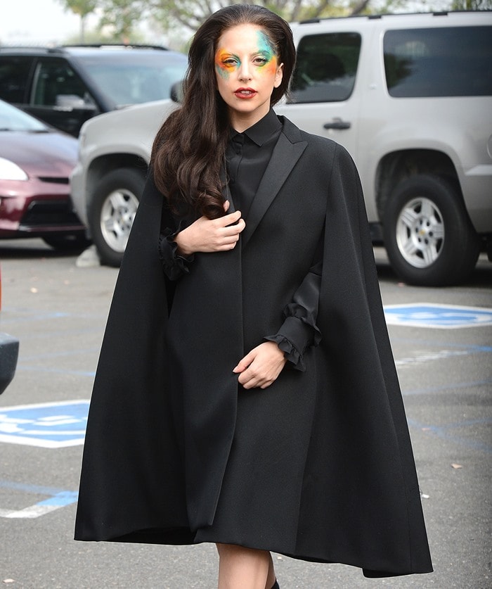 Lady Gaga channels her inner goth with a Saint Laurent wool cape, adding a mysterious touch to her all-black attire