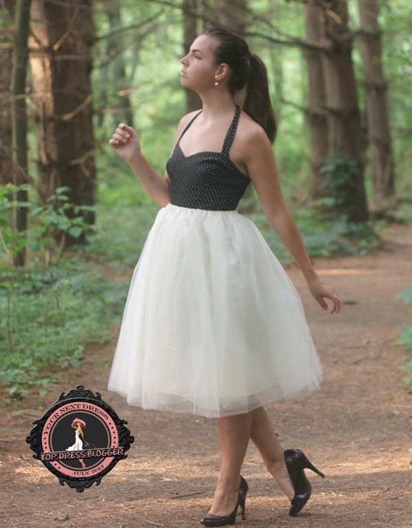 Lauren in a whimsical A-line tulle dress with black pumps