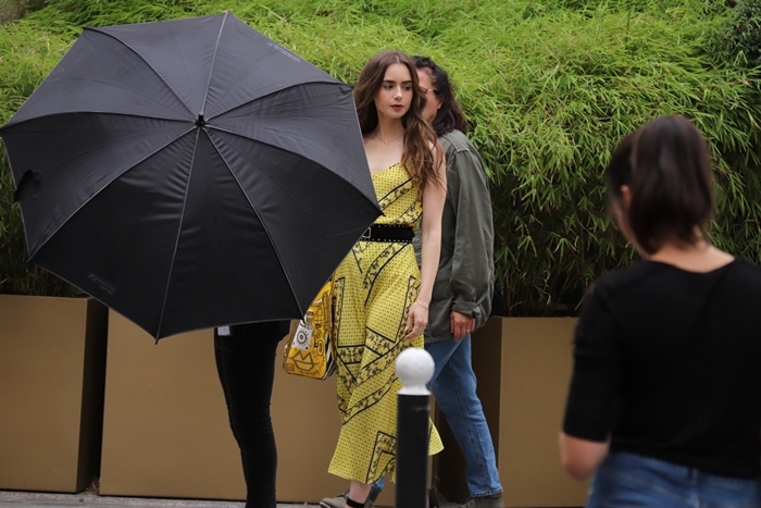 Actress Lily Collins is seen on the set of 'Emily in Paris' on August 13, 2019, in Paris
