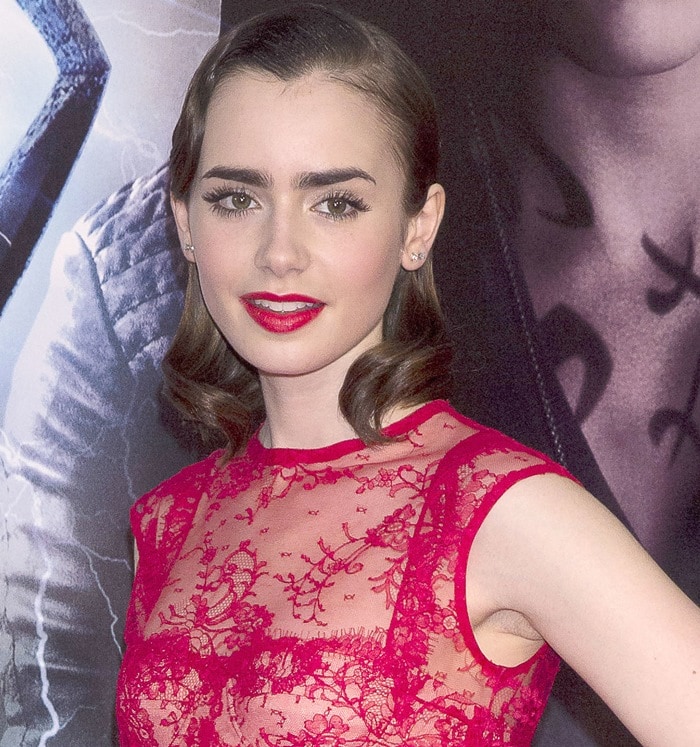 Lily Collins wearing a red lace Houghton frock