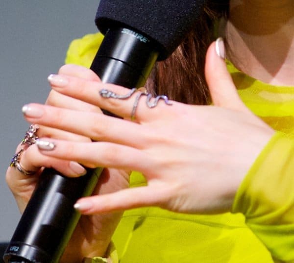 Lily Collins flaunts an exquisite snake knuckle ring, adding an edgy touch to her ensemble