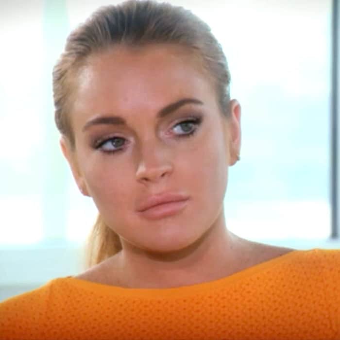 Lindsay Lohan wore a high-necked, cap-sleeved, fit-and-flare dress in a bright orange color that some have described as "prison orange"