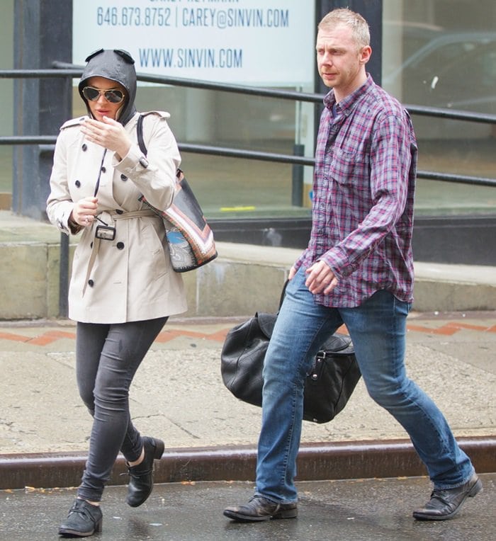 Lindsay Lohan spotted in New York wearing a double-breasted trench coat, skinny jeans, Ray-Ban sunglasses, Givenchy Antigona printed shopping bag, and Oxford shoes