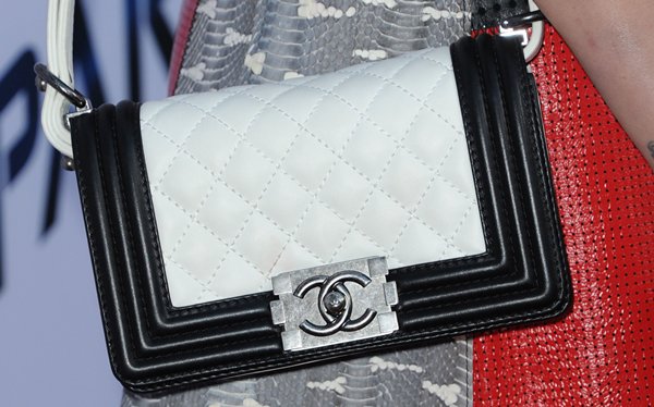 Miley Cyrus shows off her chic black and white Chanel Boy Bag