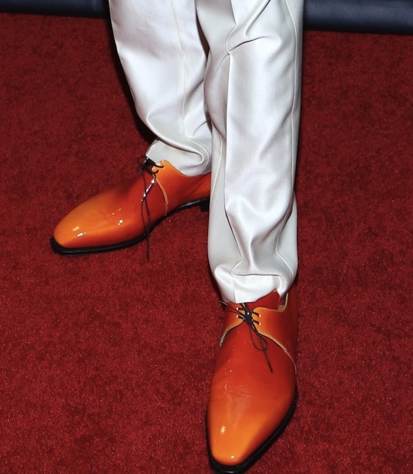 Nick Cannon wearing shiny red oxfords