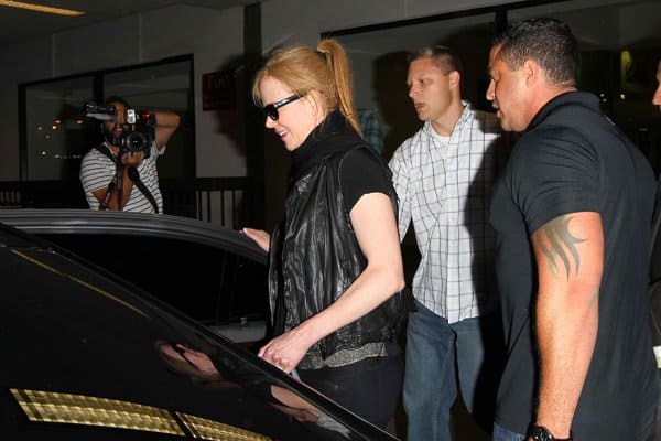 Nicole Kidman being ushered into an awaiting car by her bodyguards after arriving at Los Angeles International Airport (LAX) on August 12, 2013