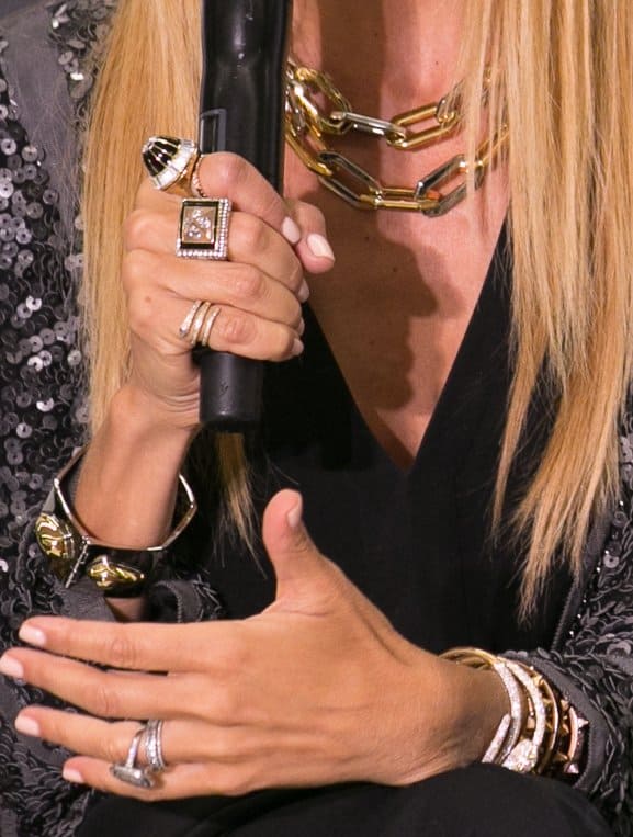 Rachel wore an assortment of jewelry — chunky cuffs, gold chains, and a variety of art deco rings, and almost all are bejeweled with sparkly stones