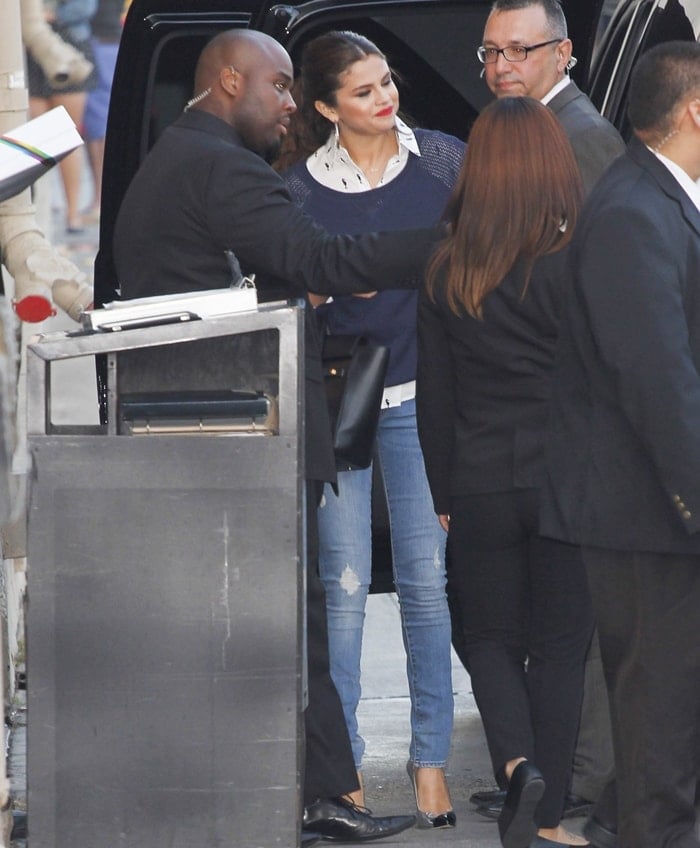 Selena Gomez wearing jeans with a GAP collared top and sweater