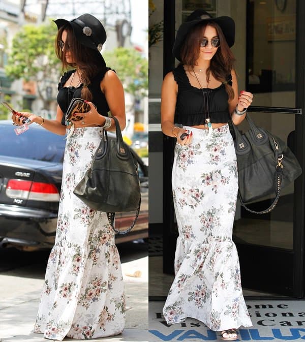 Vanessa Hudgens elegantly dons black sandals with a For Love & Lemons attire featuring a 'Holy' floral maxi skirt and a 'Lisbon' top, showcasing her impeccable fashion sense