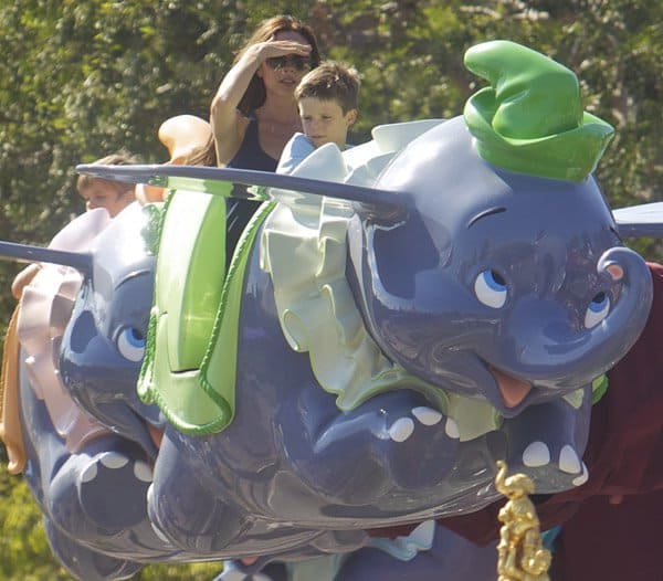 Victoria Beckham enjoys the aerial carousel-style Dumbo the Flying Elephant ride