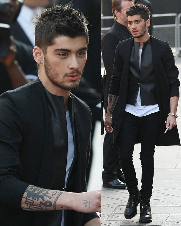 Zayn Malik in a leather harness jacket paired with a coat at the One Direction: This Is Us world premiere