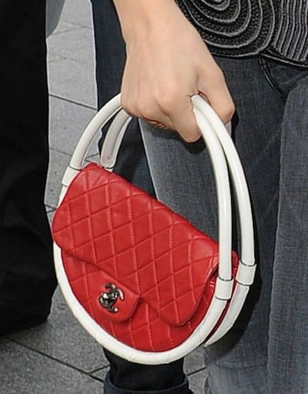 Close-up of Chloë Moretz showcasing her Chanel Hula Hoop handbag—a bold piece from the Spring 2013 collection—sparking both admiration and debate among fashion enthusiasts