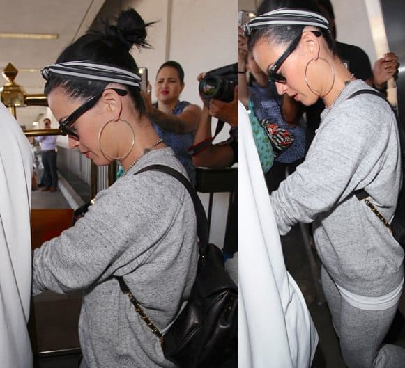 Katy Perry spotted at LAX sporting a chic black-and-white striped headscarf, effortlessly elevating her casual grey sweatsuit, August 14, 2013