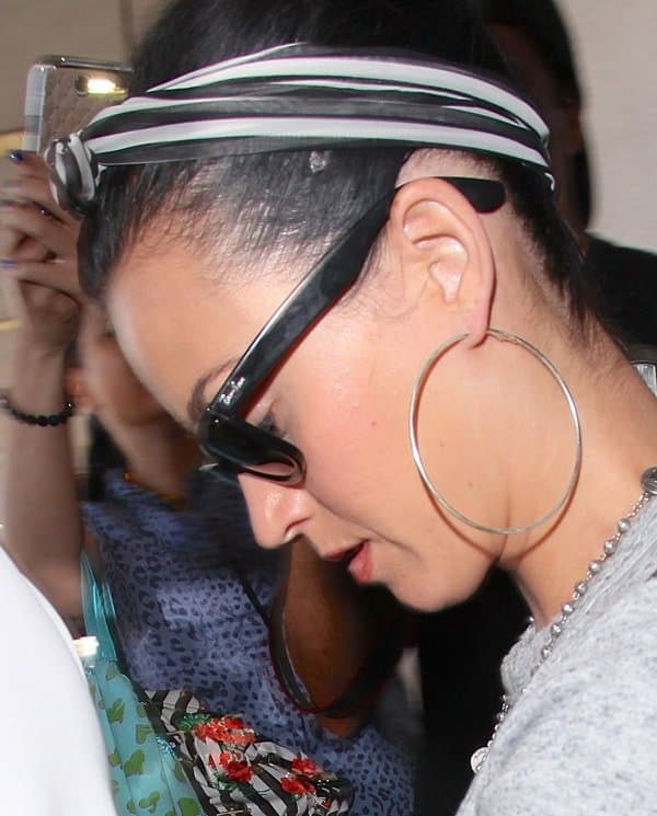 Close-up of Katy Perry at LAX: The pop icon makes a style statement with a striking black-and-white striped headscarf, August 14, 2013
