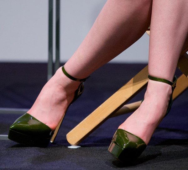 Lily Collins completes her vibrant look with glossy green Casadei heels at a promotional event