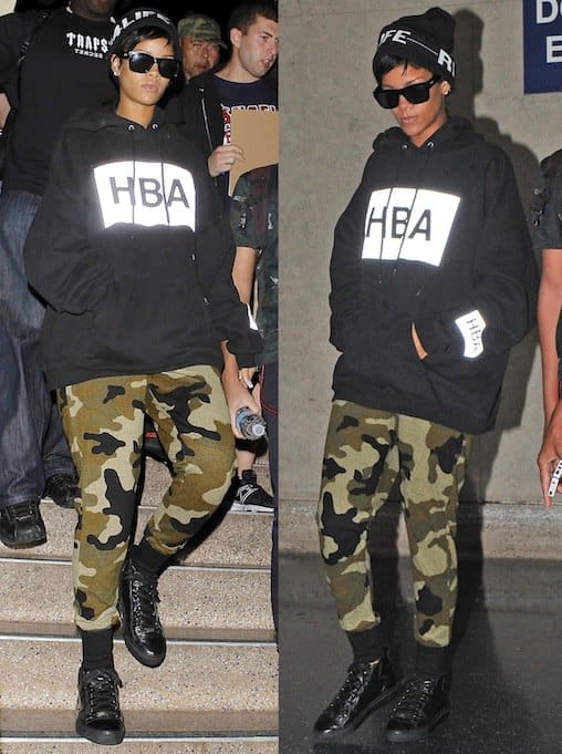 Rihanna pairing an oversized black hoodie by Hood by Air with camo-printed sweatpants and black combat boots, embodying a cool and casual hip-hop vibe