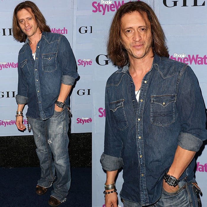 Clifton Collins Jr. embraces a rugged double-denim look, pairing a classic denim shirt with distressed jeans, accessorized with layered bracelets and worn leather shoes