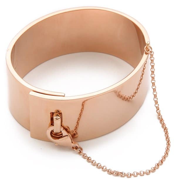 This sleek, hinged Eddie Borgo cuff forms a liquid band around the wrist, and a delicate lobster-claw chain secures the hook-and-eye closure.