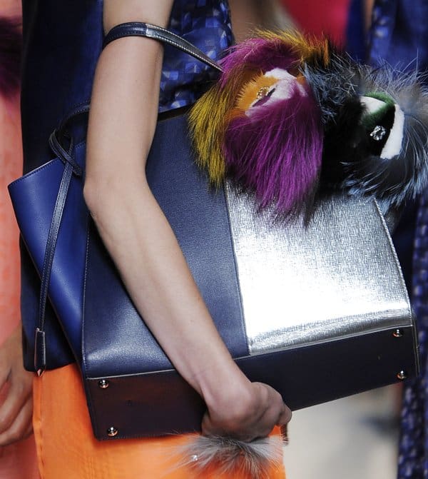 Fendi's bold blue handbag with metallic accents and colorful fur embellishments, featured at Milan Fashion Week Spring/Summer 2014