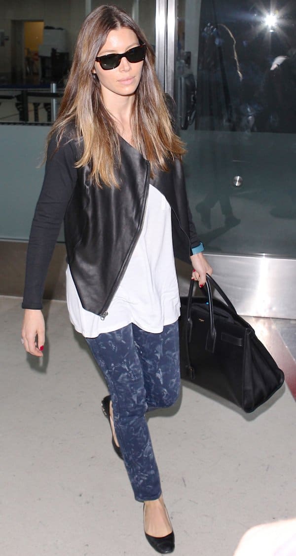 On September 11, 2013, at LAX Airport, Jessica Biel wore Tom Ford Snowdon sunglasses, MiH Ellsworth Blue Salt skinny jeans, a Michael Stars leather front moto jacket, an Alexander Wang V-neck T-shirt, Chanel chain heel flats, and carried a Saint Laurent Sac De Jour bag