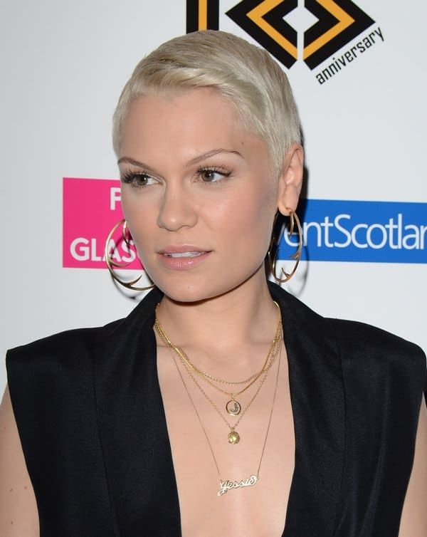 Jessie J shows off her Jessie J logo necklace and numerous gold chains