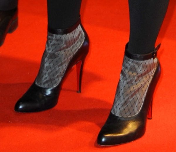 Katy Perry's "Resillissima" Louboutin booties exuded a distinctive personality with their fishnet panels on the uppers