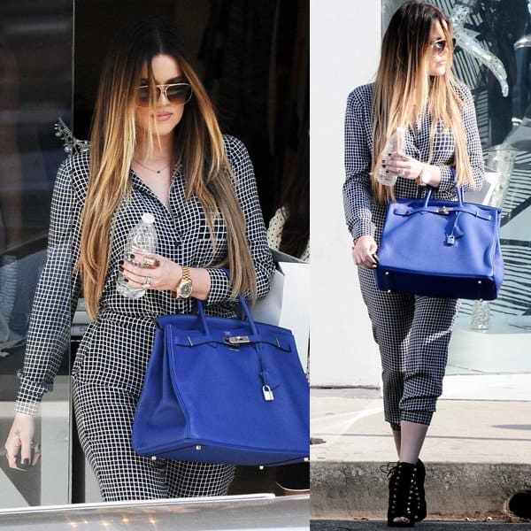 Khloe Kardashian sported a windowpane plaid jumpsuit, which she styled with a pair of black booties by Giuseppe Zanotti