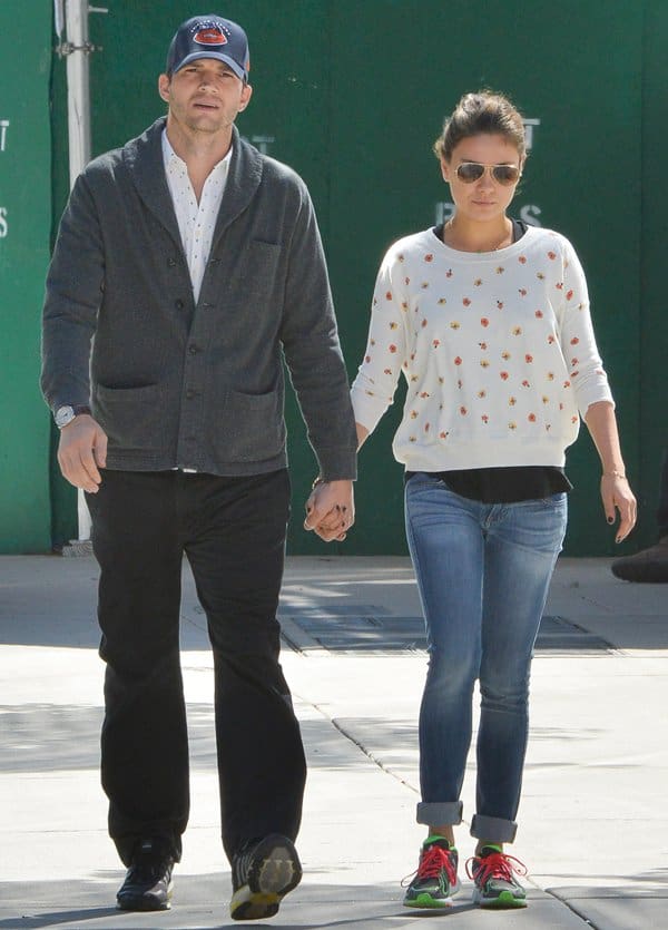 Mila Kunis pairs neon-accented Nike Free sneakers with cuffed skinny jeans while walking hand-in-hand with Ashton Kutcher in SoHo, New York City, on September 19, 2013