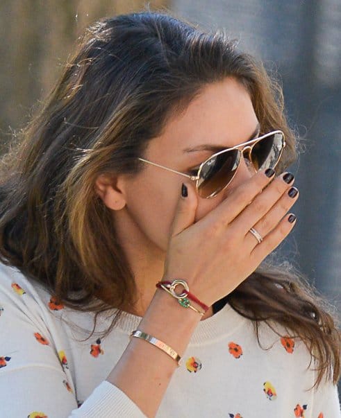 Mila Kunis shows off her jewelry and red string bracelet with golden hoops