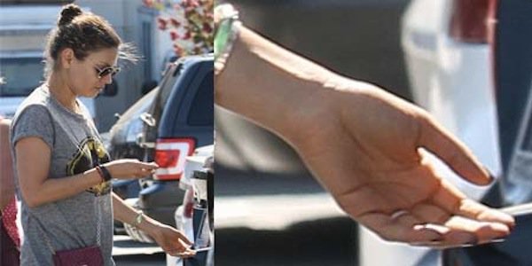 Mila Kunis sporting a gold band on her left ring finger