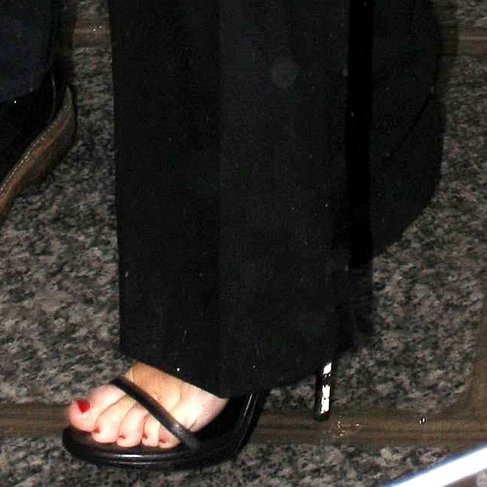 Miley Cyrus' feet in white-snake-heeled sandals