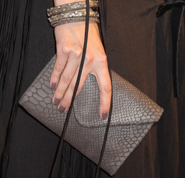 Mischa Barton totes a clutch and shows off her manicure