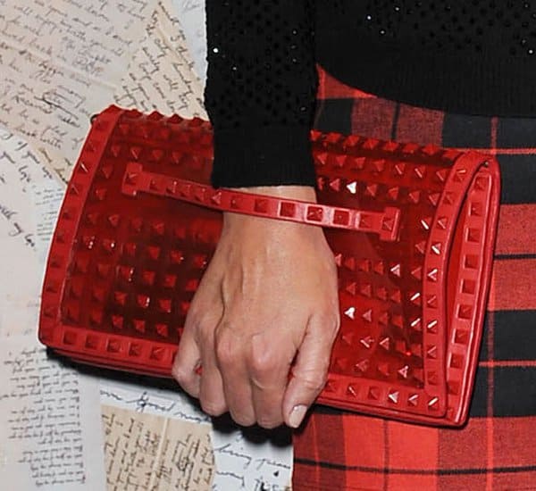 Nicky Hilton carrying a Valentino Rockstud rouge patent clutch