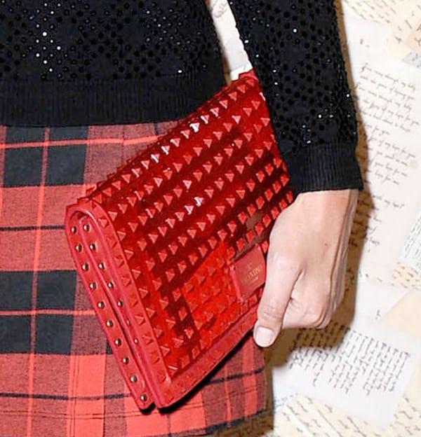 Nicky Hilton carrying a Valentino Rockstud rouge patent clutch