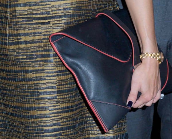 Olivia Palermo holding a red-trimmed leather envelope clutch from Reiss