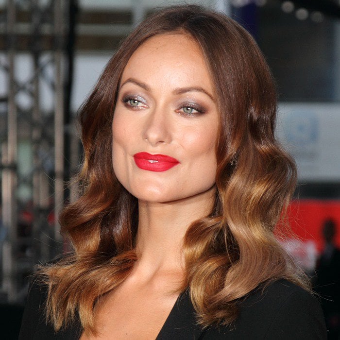 Olivia Wilde's wavy locks and bold red lipstick elevate her daring Gucci outfit at the 'Rush' premiere