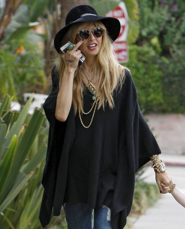 Rachel Zoe was spotted in a chic bohemian-inspired ensemble featuring a black caftan top and flared jeans