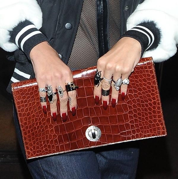 Rihanna accessorizes with a vintage Celine clutch crafted from exotic crocodile leather, showcasing luxury in every detail