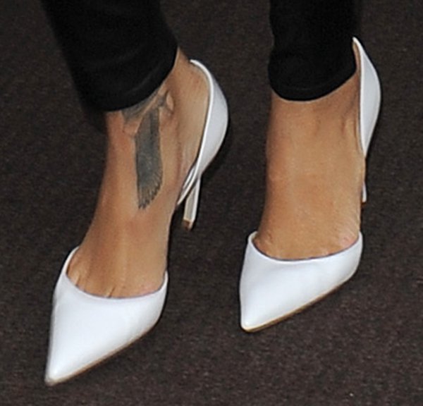 Rihanna steps out in sleek white Manolo Blahnik pumps, showcasing her ankle tattoo for an effortlessly chic touch