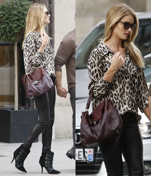 On September 25, 2013, in Paris, France, Rosie Huntington-Whiteley wore Anine Bing leather skinny pants, a L'Agence leopard-print blouse, Isabel Marant Tacy suede and calf hair ankle boots, Givenchy square tortoise sunglasses, and carried a Lanvin For Me two-tone leather satchel